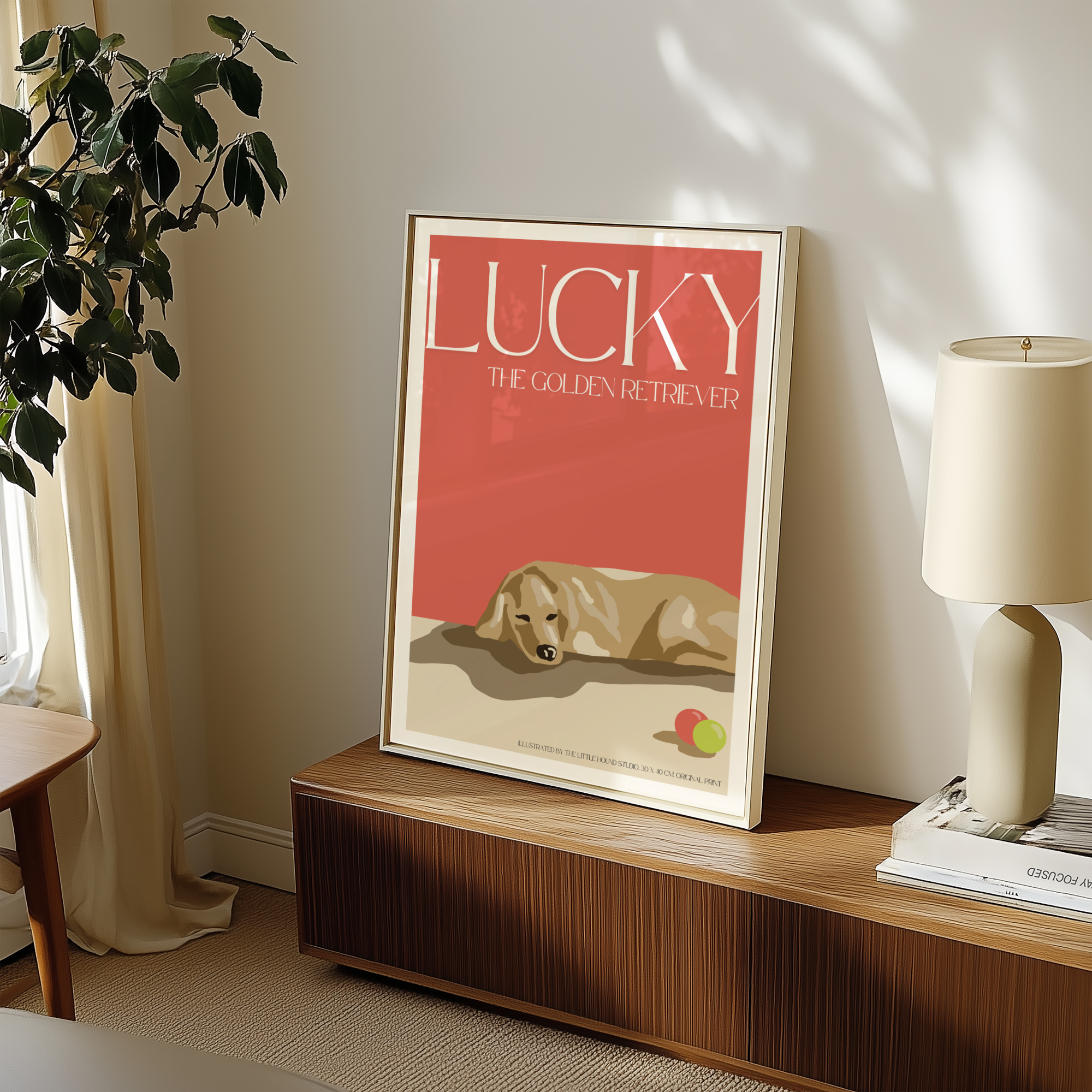 A custom pet portrait of Lucky the golden retriever, beautifully framed and leaning against the wall on a sleek midcentury modern TV console. The artwork captures Lucky’s warm and friendly expression, complementing the rich wood tones, clean lines, and retro-inspired décor of the space.